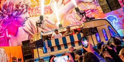 The unique back patio of We All Scream in Downtown Las Vegas featuring a DJ performing from a vintage ice cream truck