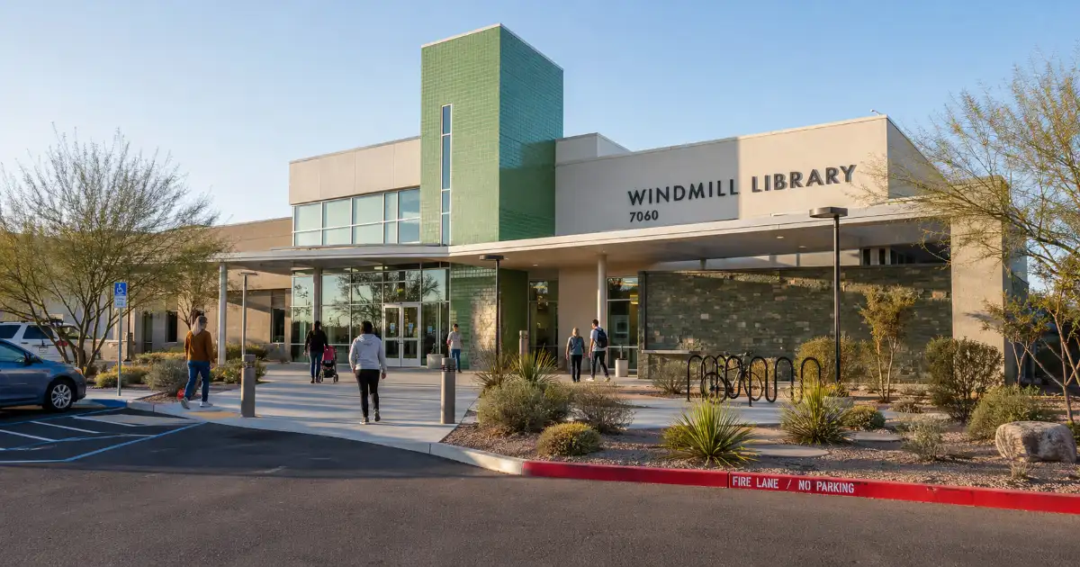 The modern Windmill Library exterior features green architectural accents, permanent signage, desert landscaping, and a paved public entrance.