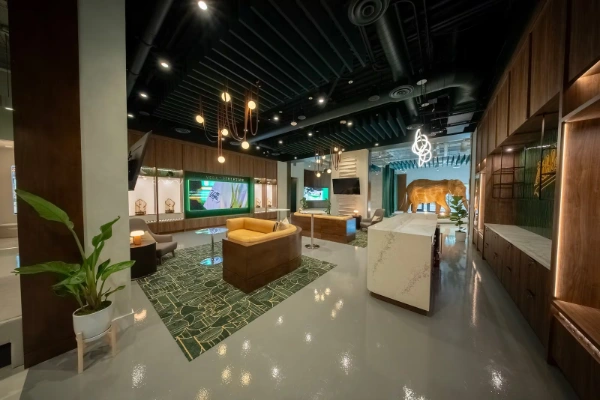 Stylish lounge at Las Vegas As preview center with elephant sculpture green accents and sports branding