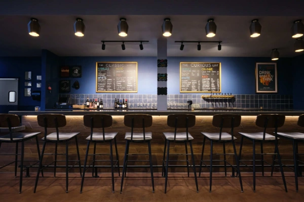 Interior of Crush Pad Wine Bar tasting room in Las Vegas featuring high stools chalkboard wine menus and modern decor