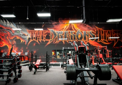 Interior of Dragon's Lair Gym showing specialized weightlifting area and custom equipment