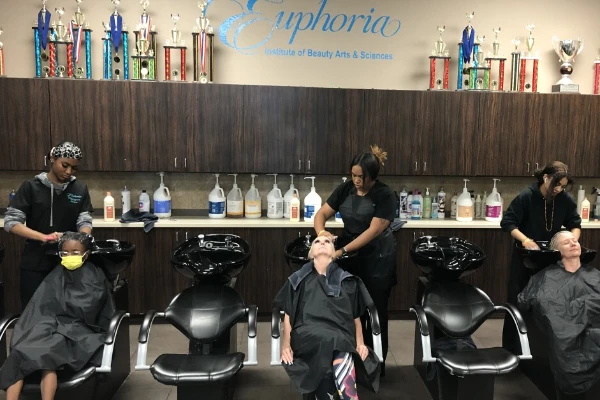 Students practicing hair styling techniques at Euphoria Institute of Beauty Arts and Sciences in Las Vegas