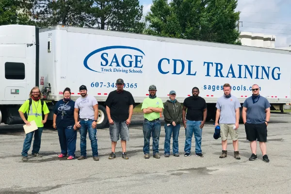 Students standing in front of a SAGE CDL Training semi-truck trailer during a commercial driver’s license course in Las Vegas