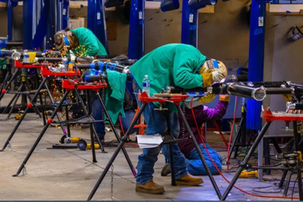 Apprentices practicing pipefitting and commercial plumbing techniques at a UA Local 525 JATC training center