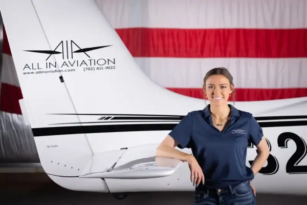 Student pilot posing in front of an airplane at All In Aviation flight school near Las Vegas