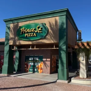 Exterior view of the Prince St. Pizza location at 2390 East Serene Avenue, Suite 400. The building features a large green and gold 'Prince St. Pizza' sign above a brick storefront.