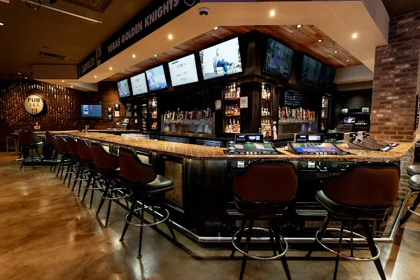 Interior of Pub 365 at Tuscany Hotel & Casino in Las Vegas featuring bar seating, beer taps, and gaming machines
