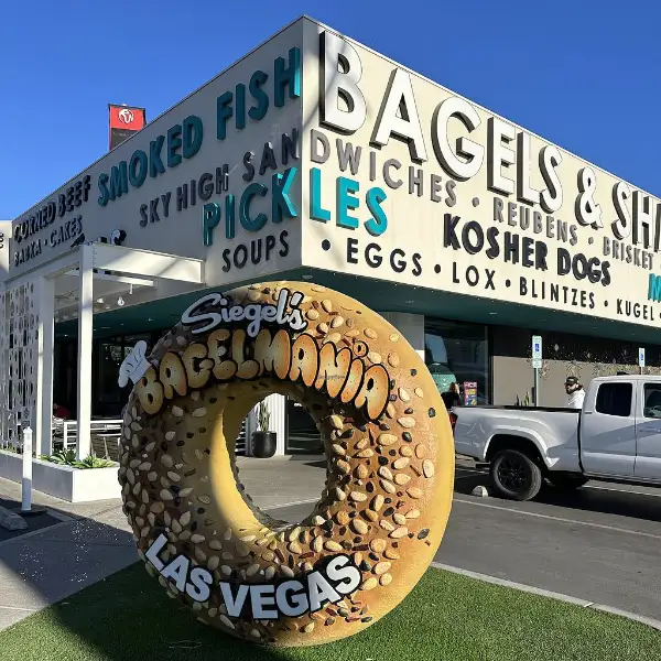 An exterior view of Siegel's Bagels in Las Vegas. I giant statute of realistic looking bagel is in view