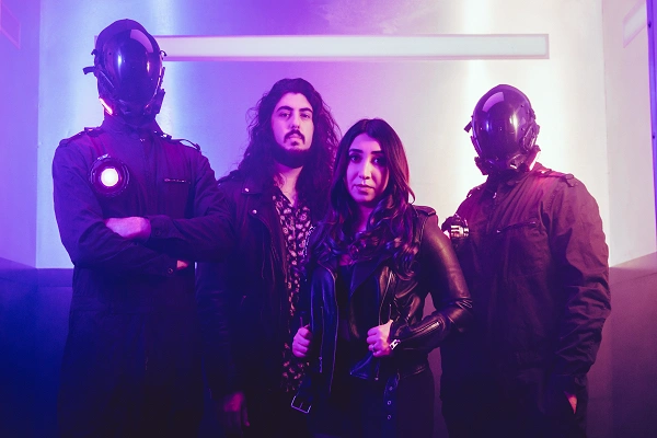 Band photo of Satellite Citi featuring Anna Gevorkian and members in a purple-lit sci‑fi setting with two performers wearing futuristic helmets
