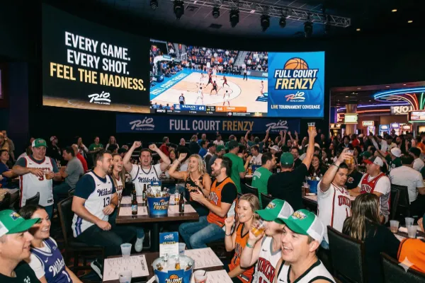 A group of basketball fans watch NCAA tournament action at the RIO Las vegas
