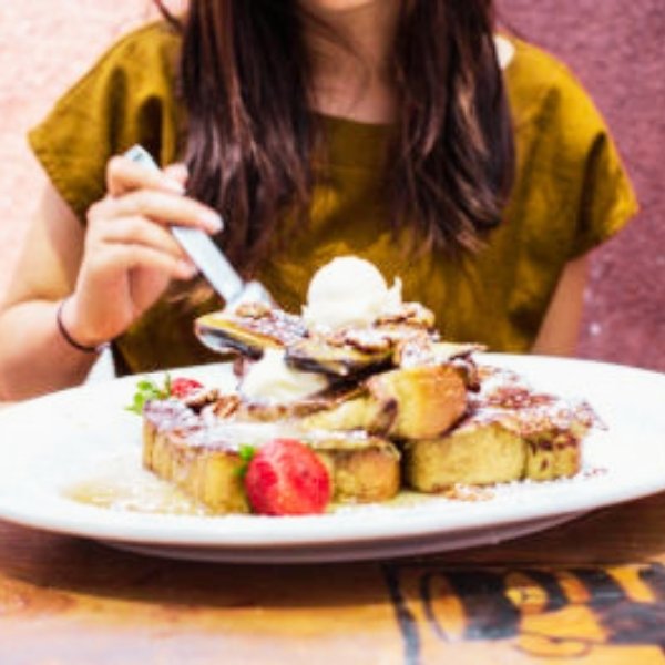 Hash House A Go Go Mother's Day Specials. Woman eating French Toast