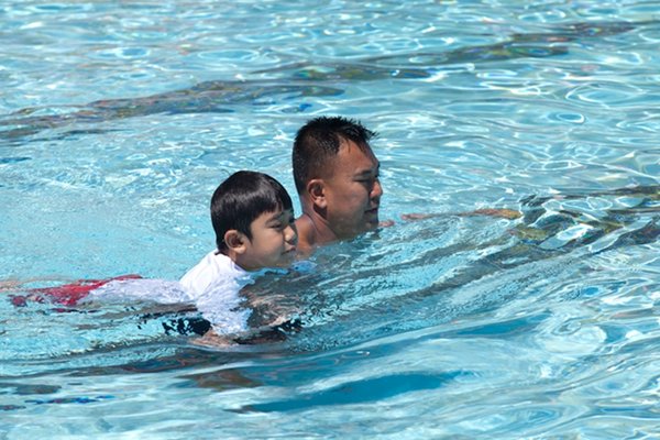 Fathers Day YMCA Centennial Hills Pool Party image of dad and son swimming