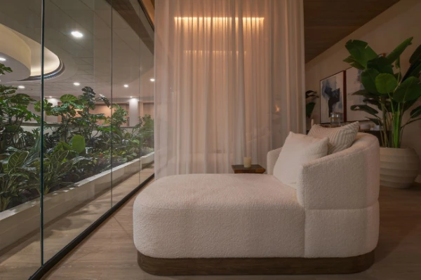 The grand outdoor co-ed hydrotherapy lounge pool featuring stone waterfall cascades at Spa Aquae in Summerlin