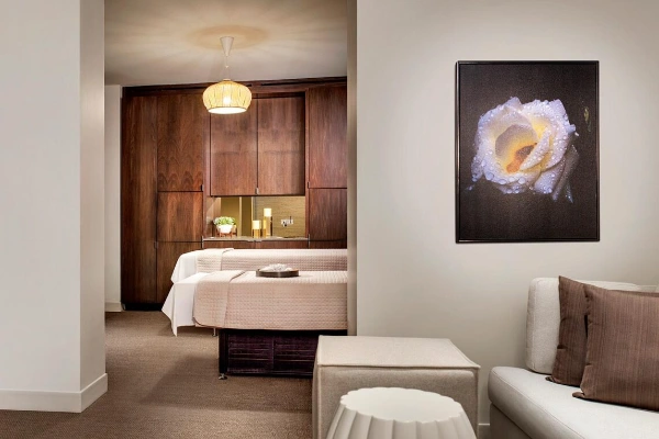 The exclusive, sunlit adult-only lap pool lined with palm trees and modern cabanas at Red Rock Spa in Summerlin