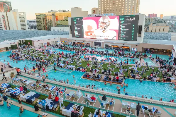 Stadium Swim at Circa Las Vegas with resort pools giant video screen and Downtown Las Vegas dayclub atmosphere