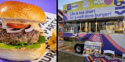 Close‑up of a juicy gourmet burger with brioche bun, tomato, onion, and creamy sauce on a purple background, styled for Burger Party Las Vegas.