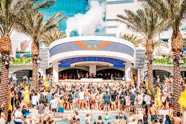 LIV Beach Dayclub at Fontainebleau Las Vegas with luxury pool party guests and DJ daylife atmosphere