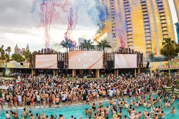 Las Vegas dayclub pool party with resort pool guests dancing drinking and enjoying DJ music in the sun