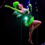 Absinthe performer in a green costume suspended above the stage at Caesars Palace in Las Vegas.