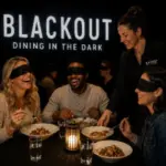 Guests experiencing a mystery dinner at BLACKOUT Dining in the Dark Las Vegas