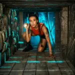 A woman explores a misty tunnel while trying to find an escape from the Blair Witch Escape Room in Las Vegas