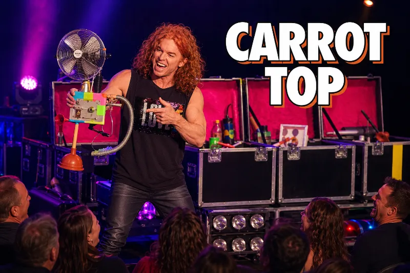 Carrot Top presents a colorful homemade comedy prop before a laughing Las Vegas audience.