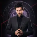 Colin Cloud poses before a clockwork backdrop representing the deduction and mentalism of Mastermind.
