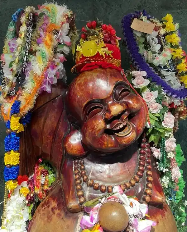 Full-length view of the wooden Happy Buddha statue at California Hotel and Casino