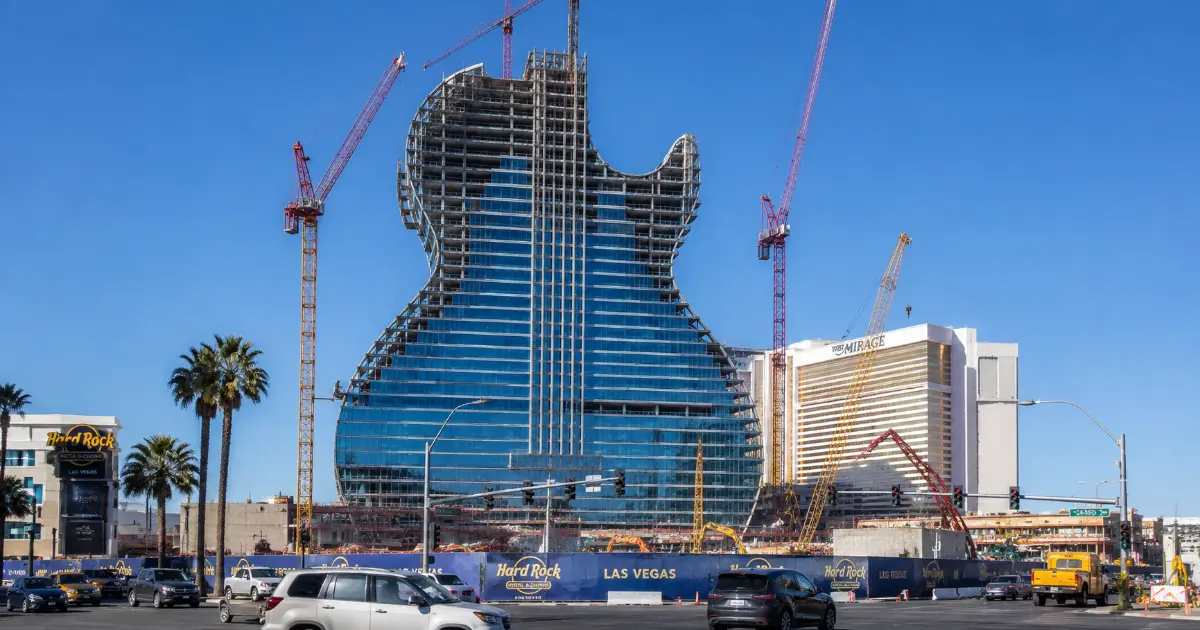 The blue-glass guitar-shaped tower rises amid cranes and construction work at the future Hard Rock Las Vegas resort.
