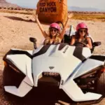 Two women pose for a picture in their Slingshot while on a Vegas Trike Tours adventure in Red Rock Canyon near Las Vegas.