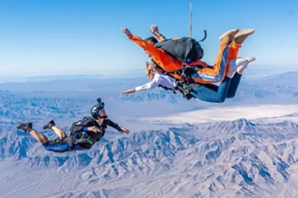 Professional tandem skydiving instructor and first-time jumper preparing for a Las Vegas skydive near Jean