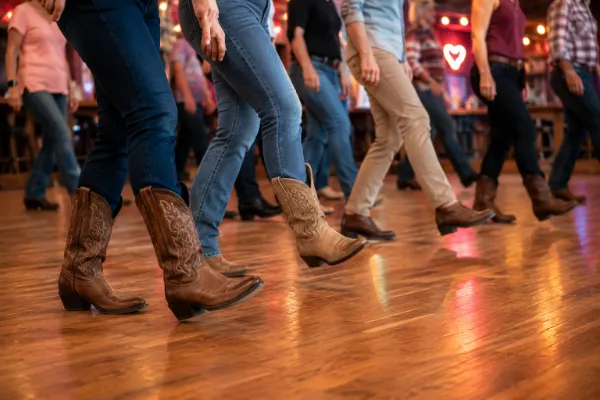 Dancers practicing coordinated line dancing steps in boots and comfortable shoes.