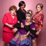 Menopause the Musical cast in colorful costumes.