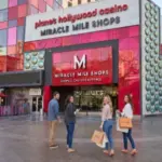 Shopper viewing digital coupons for stores, restaurants, and attractions at Miracle Mile Shops in Las Vegas.