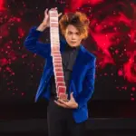 Shin Lim demonstrating card magic on stage.