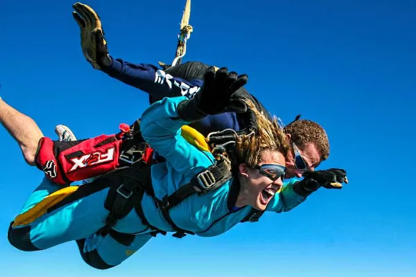 Tandem skydiver and instructor in freefall during a professional Grand Canyon skydiving media package