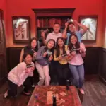 Friends celebrate their victorious escape with a group photo at The Escape Game Las Vegas.