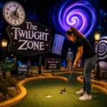 A guest plays Twilight Zone Mini Golf surrounded by glowing sci-fi effects, surreal props, and immersive themed scenery in Las Vegas.
