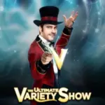 A magician wears a red top hat in V -The Ultimate Variety Show.