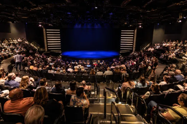 Audience seating and performance stage inside a V Theater showroom at Miracle Mile Shops in Las Vegas.