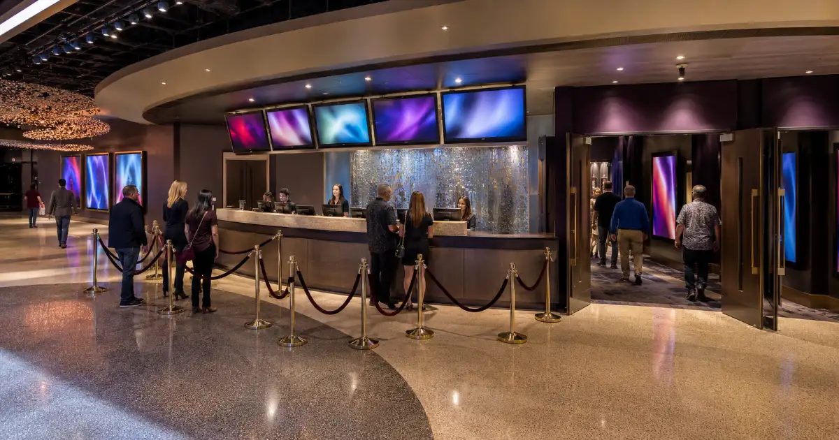 Visitors check in at the box office and enter the multi-showroom lobby at V Theater in Miracle Mile Shops in Las Vegas.
