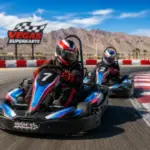 Drivers race high-speed go-karts around the outdoor Vegas SuperKarts track with desert mountains and sweeping turns near Las Vegas.