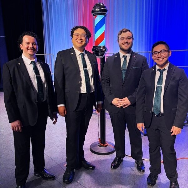 Members of the High-Stakes Barbershop Quartet performing four-part vocal harmony in Las Vegas.