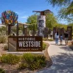 Historic Westside Legacy Park entrance with interpretive displays, public art, and visitors in Las Vegas.