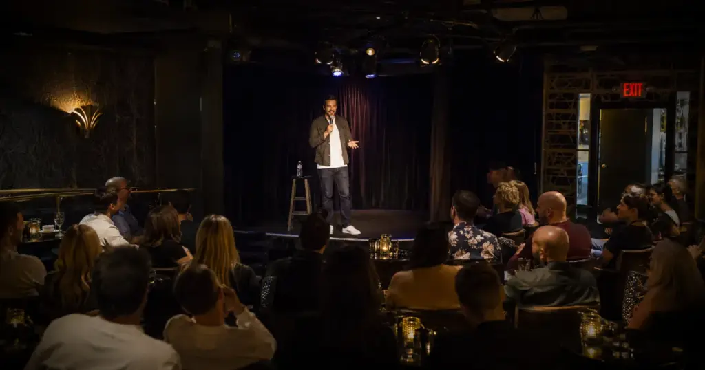 A stand-up comedian performs for an intimate audience at L.A. Comedy Club inside The STRAT Las Vegas.
