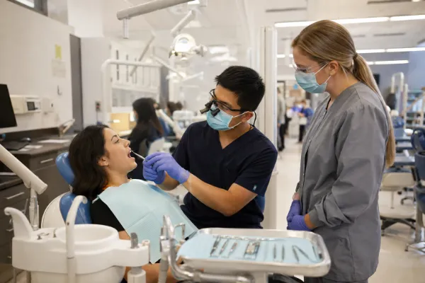 A patient receives dental care from a supervised provider at a Las Vegas community dental clinic.