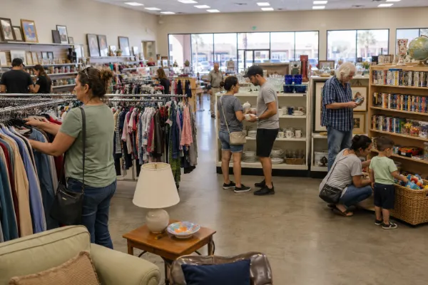 Shoppers browse clothing, housewares, and secondhand goods inside a Las Vegas thrift store.
