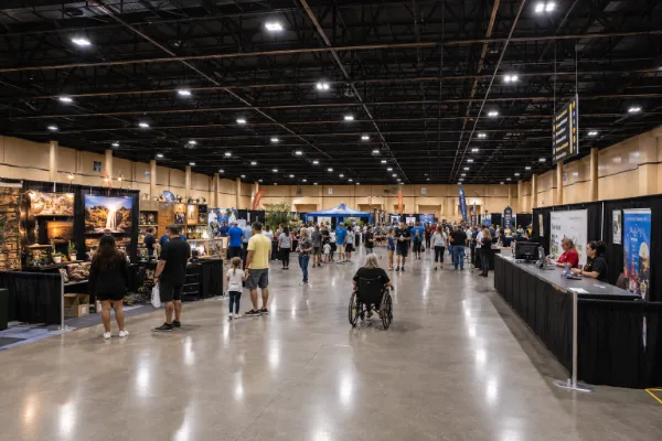 Exhibitors and attendees use wide aisles inside South Point Exhibit Hall during a trade show in Las Vegas.