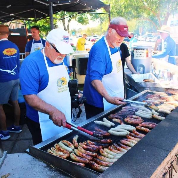 Boulder City Sunrise Rotary members grilling bratwurst and sausages at the annual Würst Festival fundraiser.