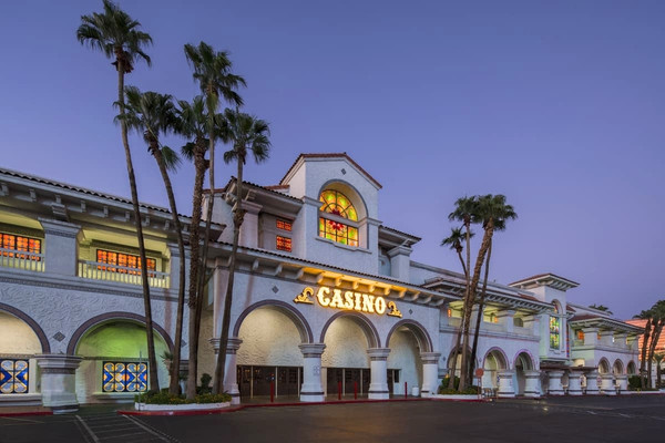 Gold Coast Hotel and Casino exterior illuminated at dusk in Las Vegas.